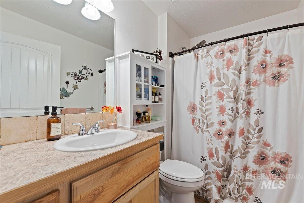 Full bath with vanity and a shower with curtain