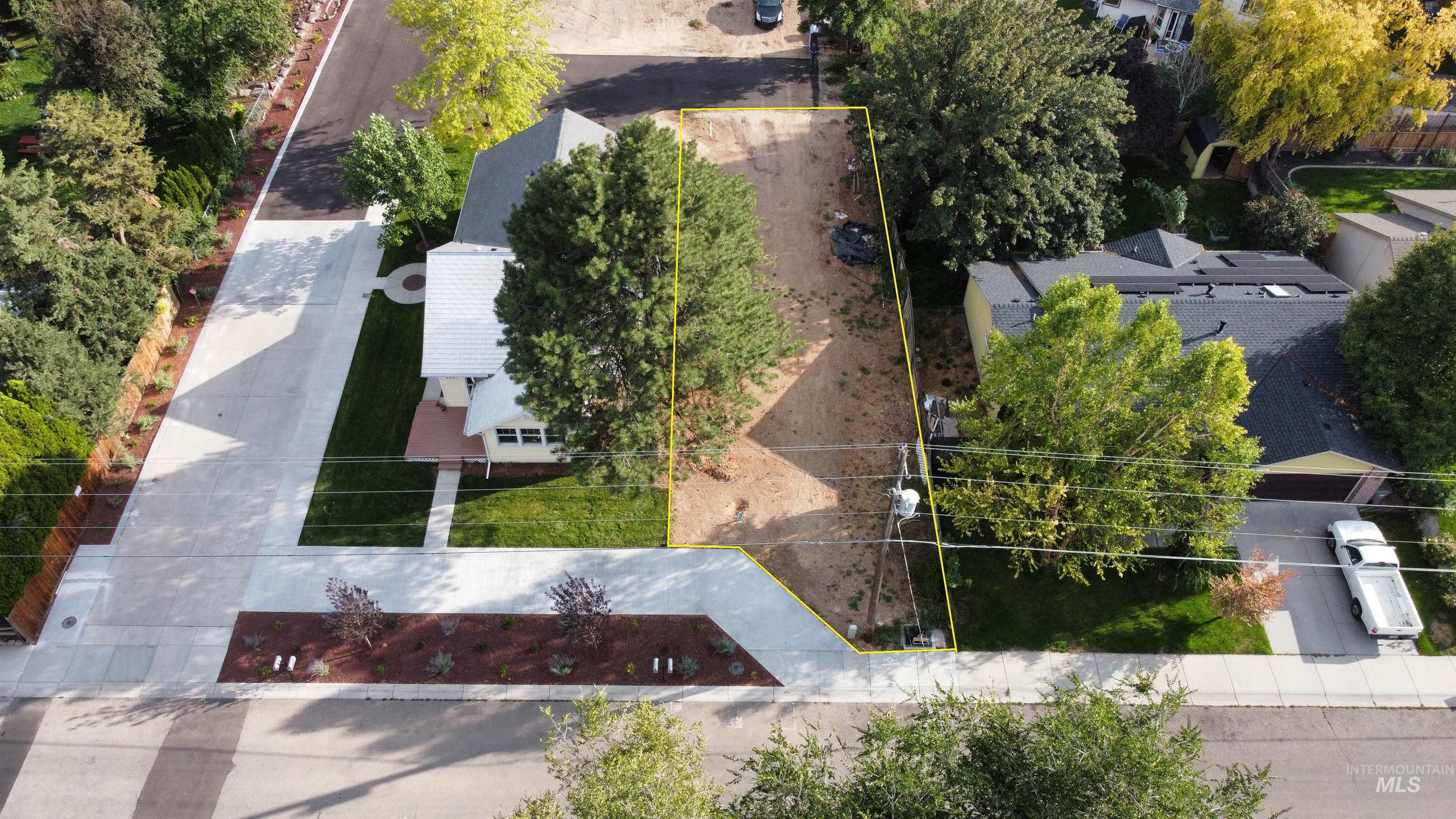Aerial view of property and surrounding area featuring property parcel outlined
