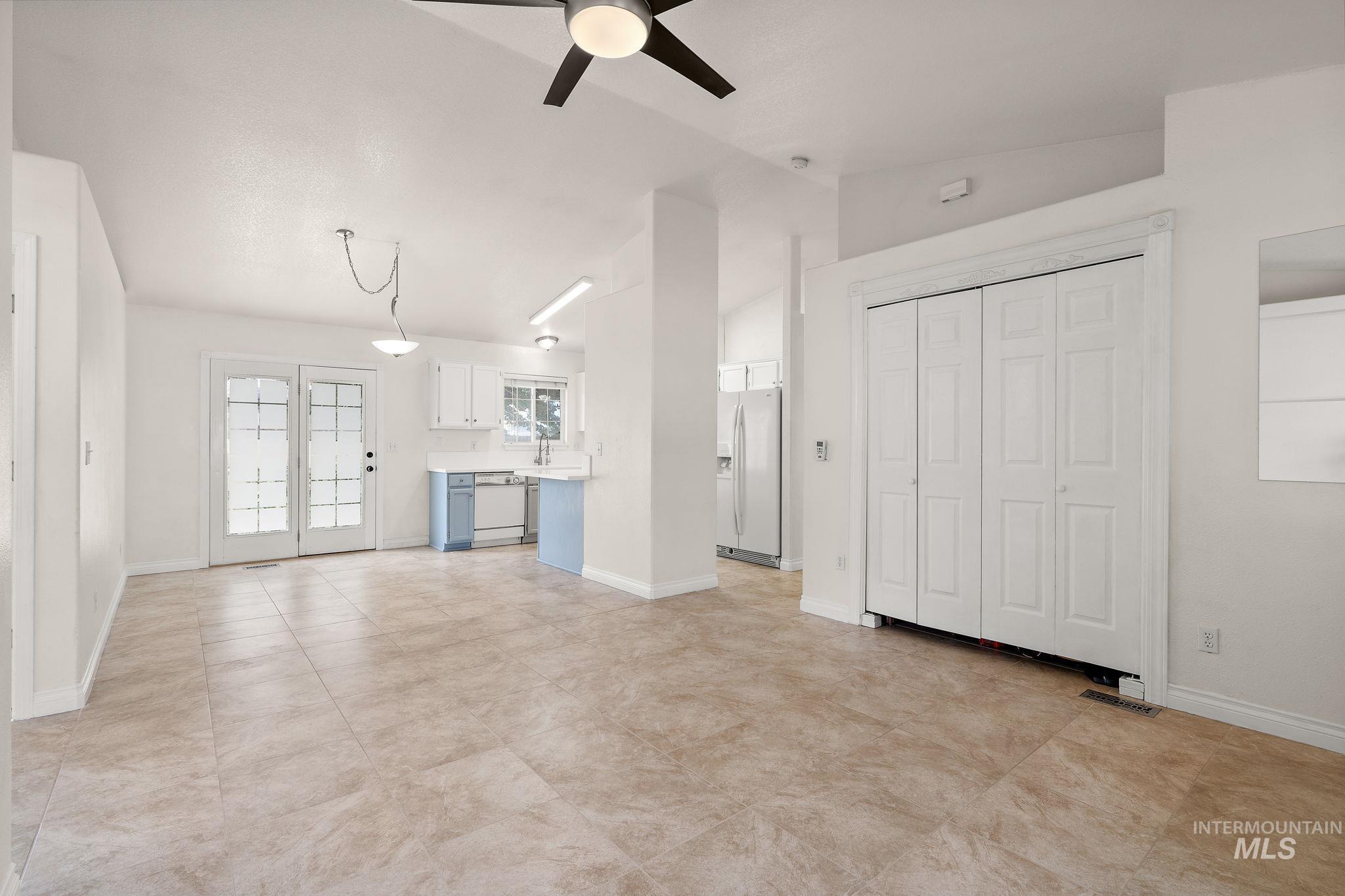 Unfurnished living room with lofted ceiling and ceiling fan