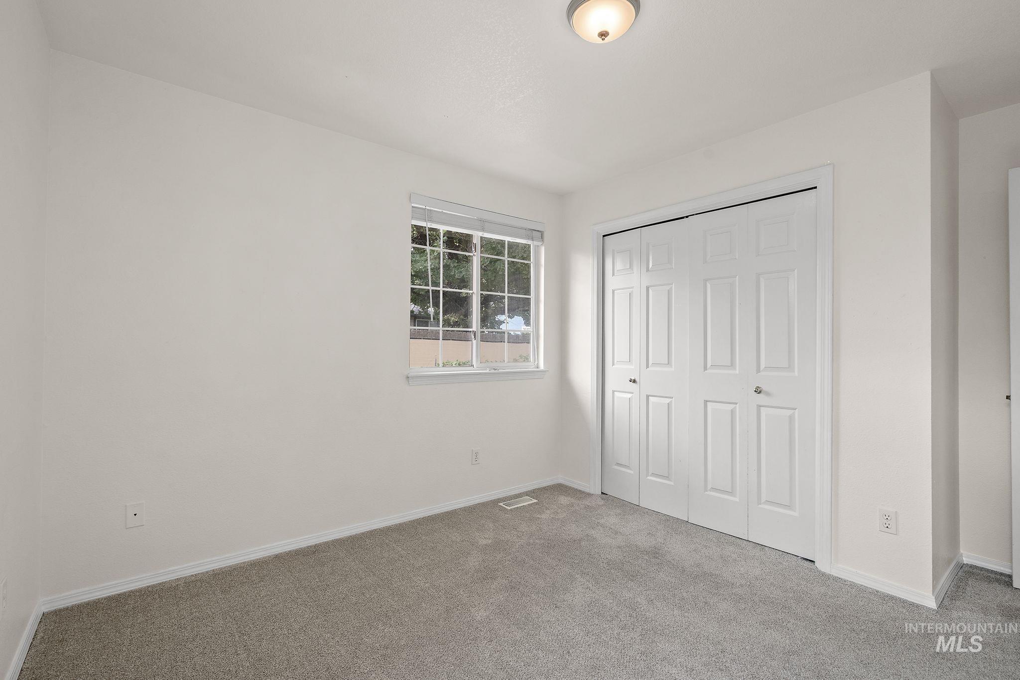 Unfurnished bedroom with carpet and a closet
