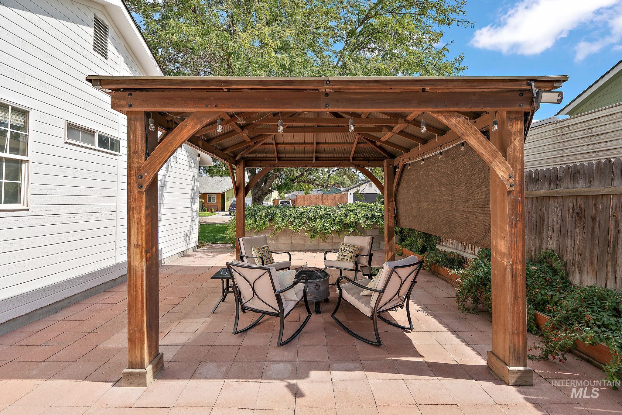 View of patio featuring a gazebo and an outdoor fire pit