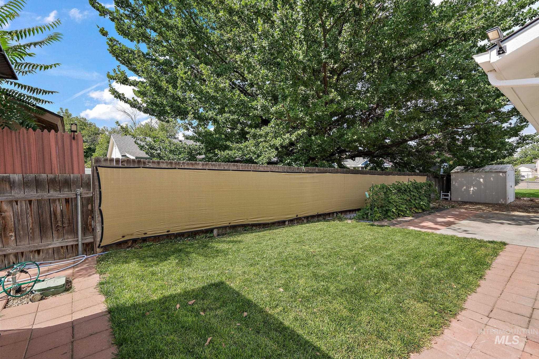 View of yard with a storage unit