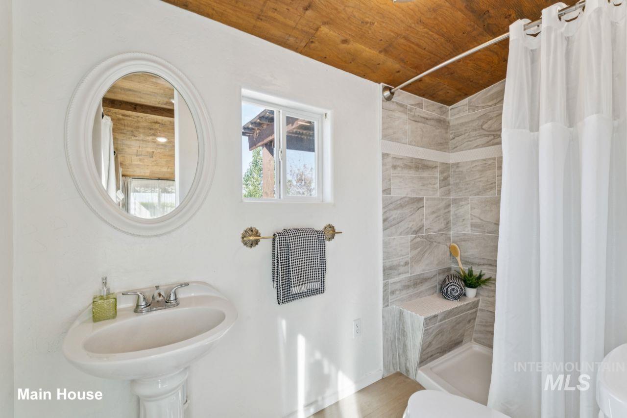 Full bath with a shower stall and wooden ceiling