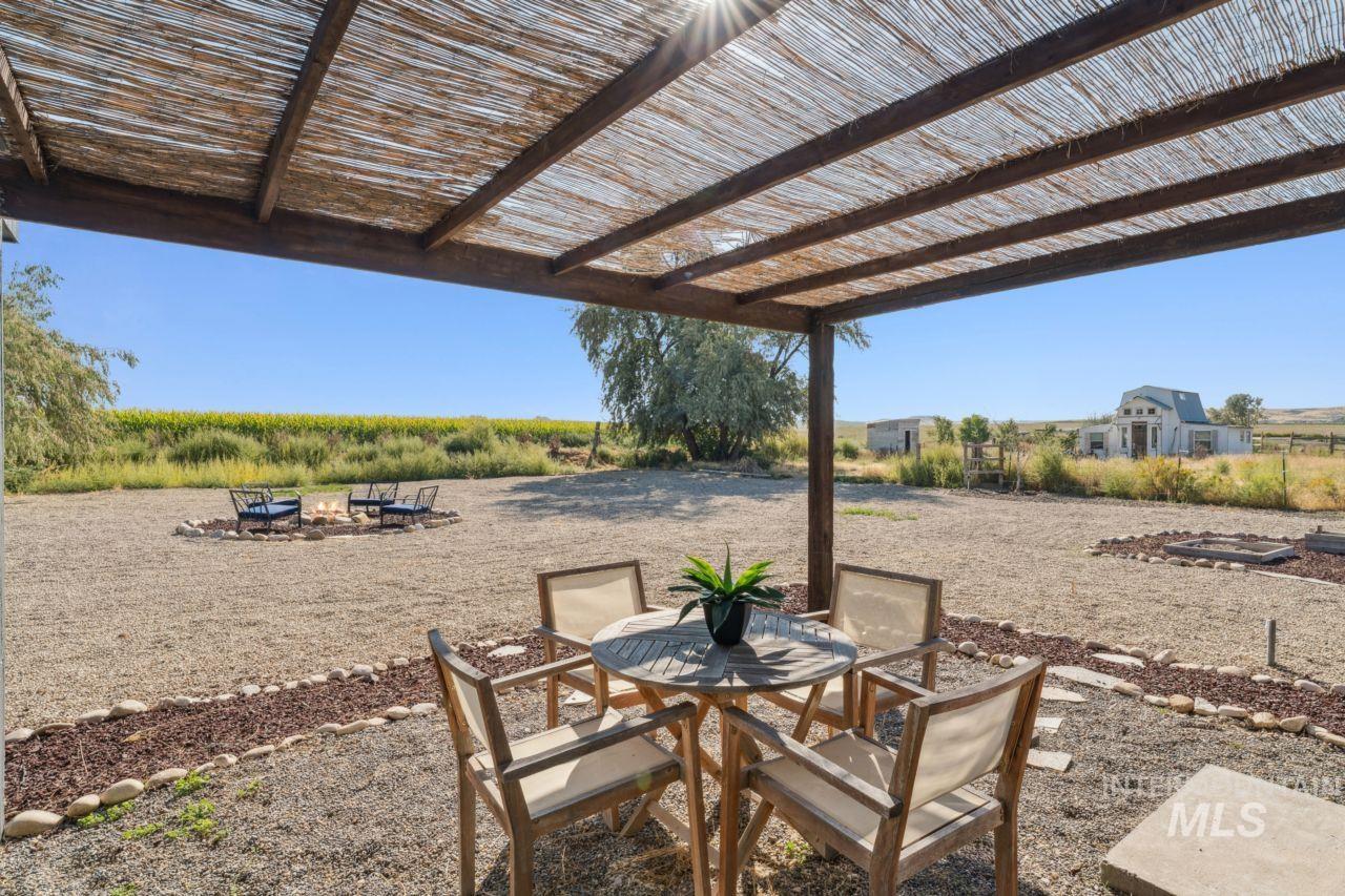 View of patio / terrace featuring outdoor dining area and an outdoor fire pit
