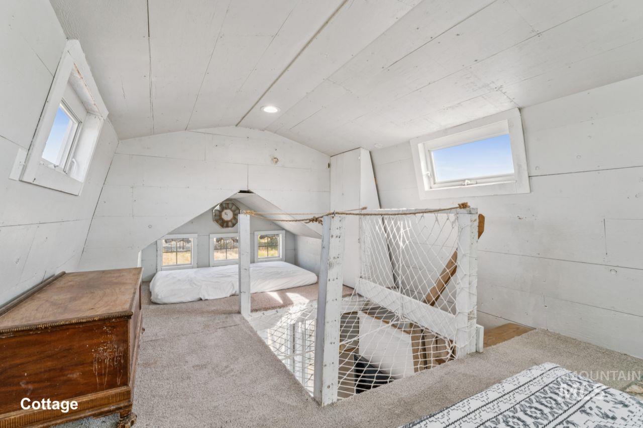 Carpeted bedroom featuring vaulted ceiling and recessed lighting