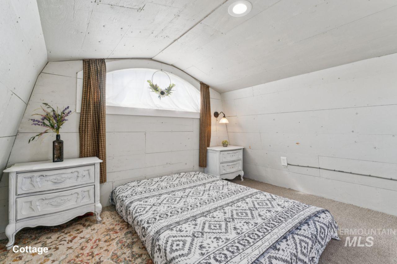 Bedroom featuring vaulted ceiling and carpet floors