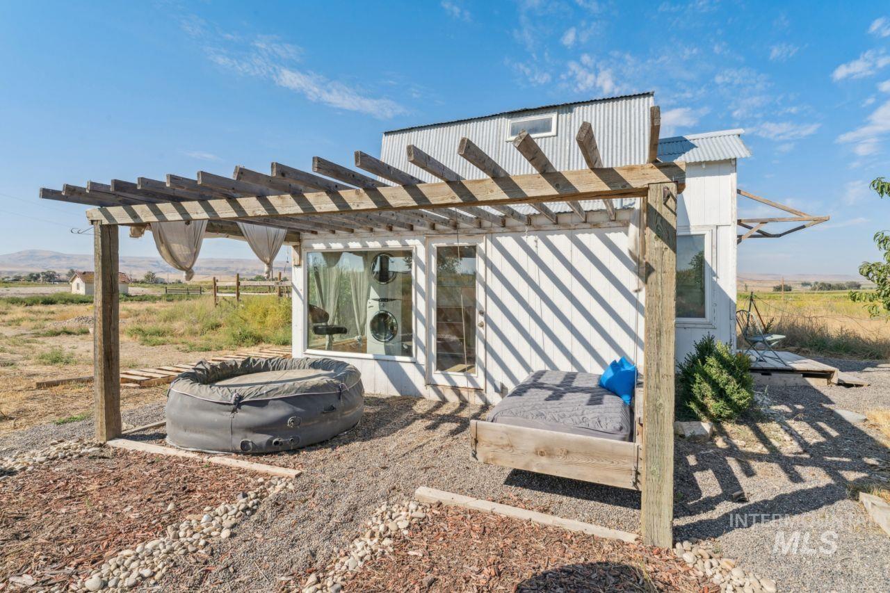 View of patio with a pergola and a view of rural / pastoral area