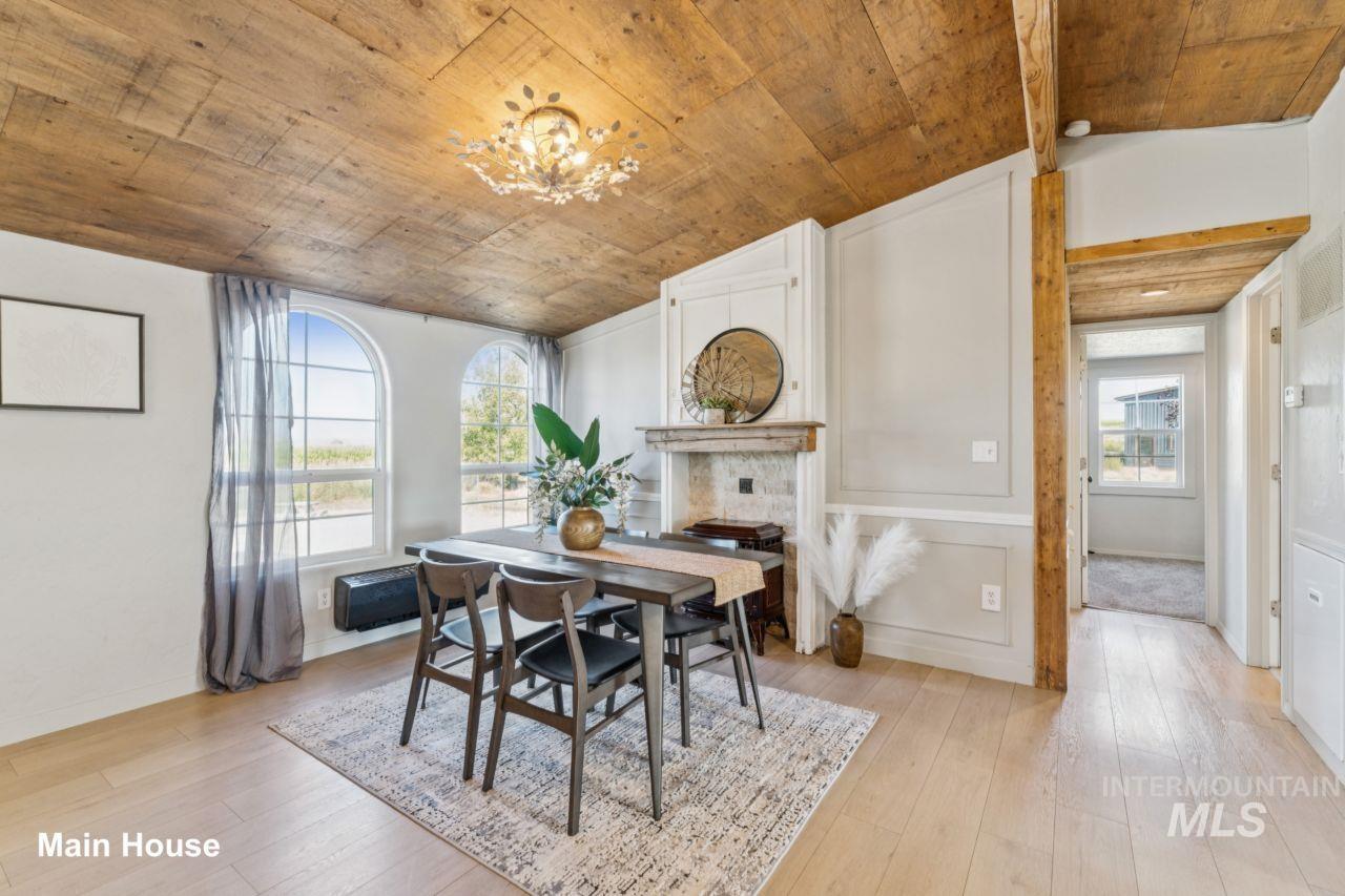 Dining space featuring light wood-style flooring, a chandelier, and lofted ceiling