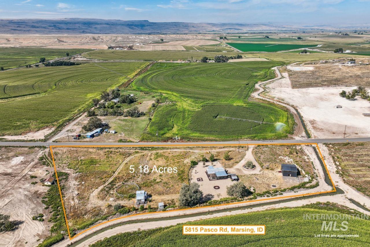 Aerial view of sparsely populated area with property boundaries highlighted and mountains