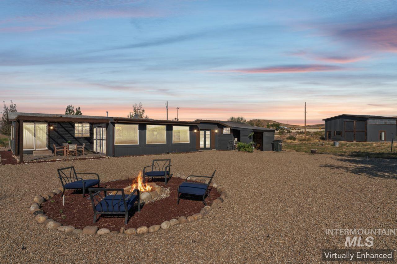 Back of property featuring a fire pit and a patio
