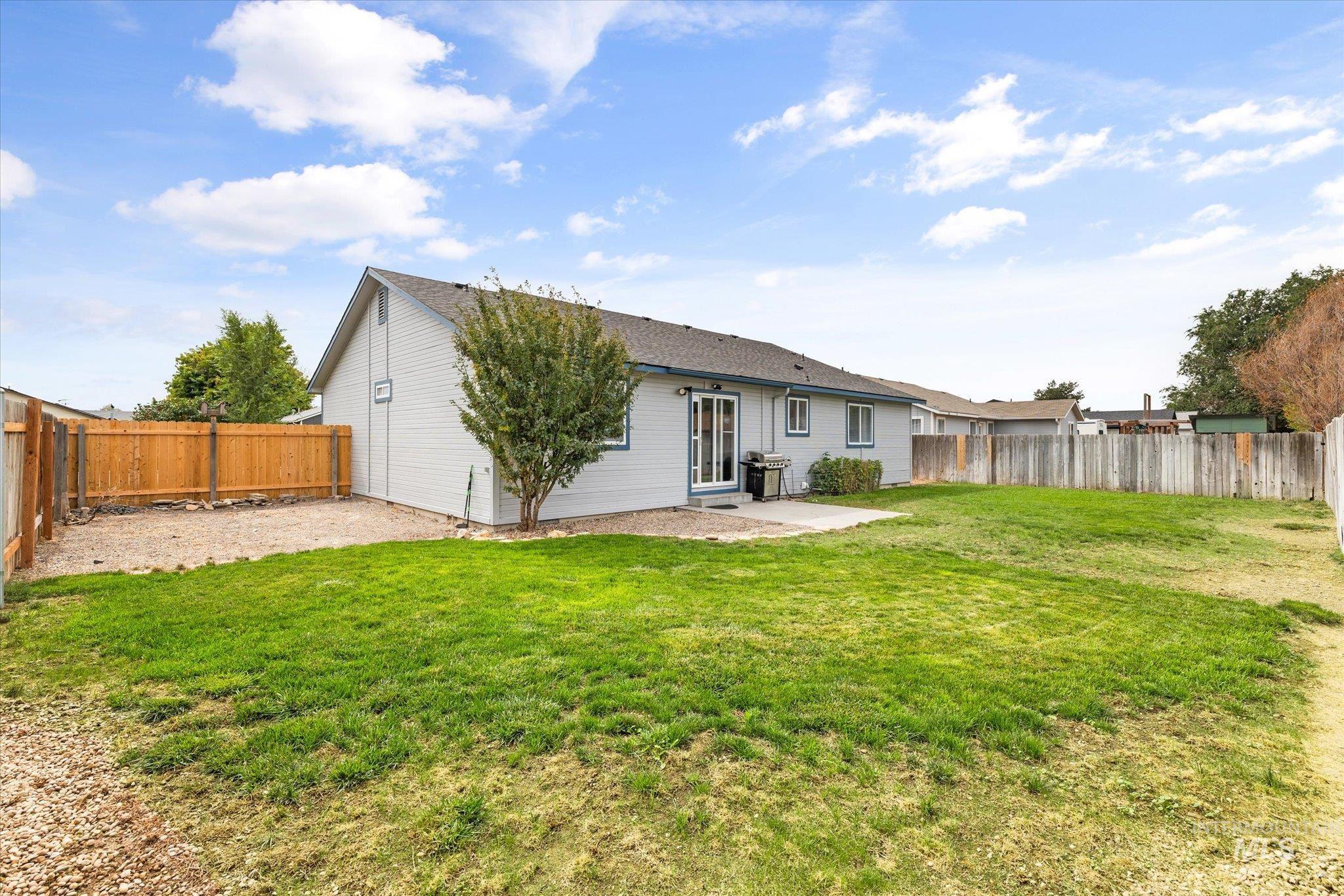 Back of property featuring a patio area and a fenced backyard