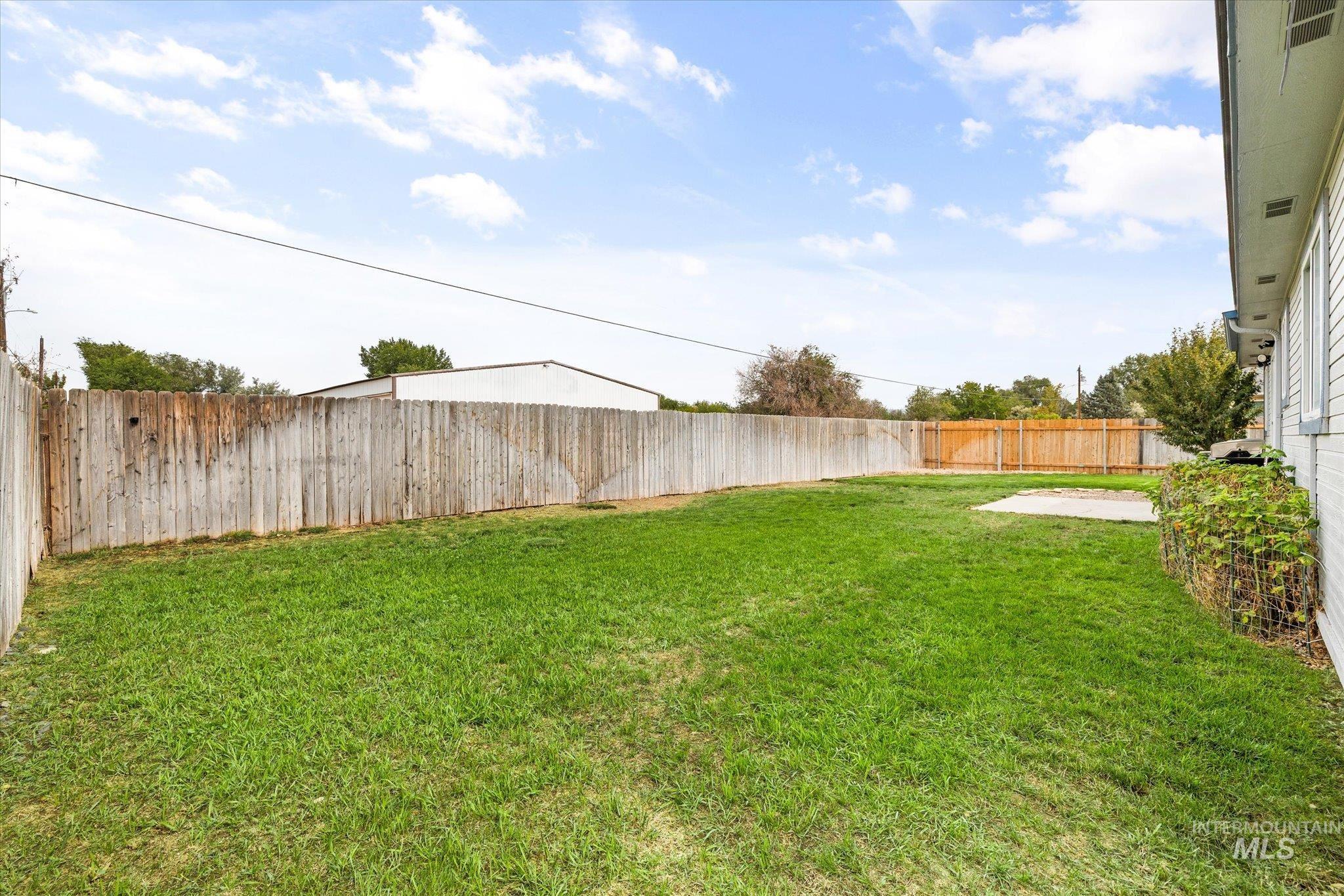 Fenced backyard featuring a patio