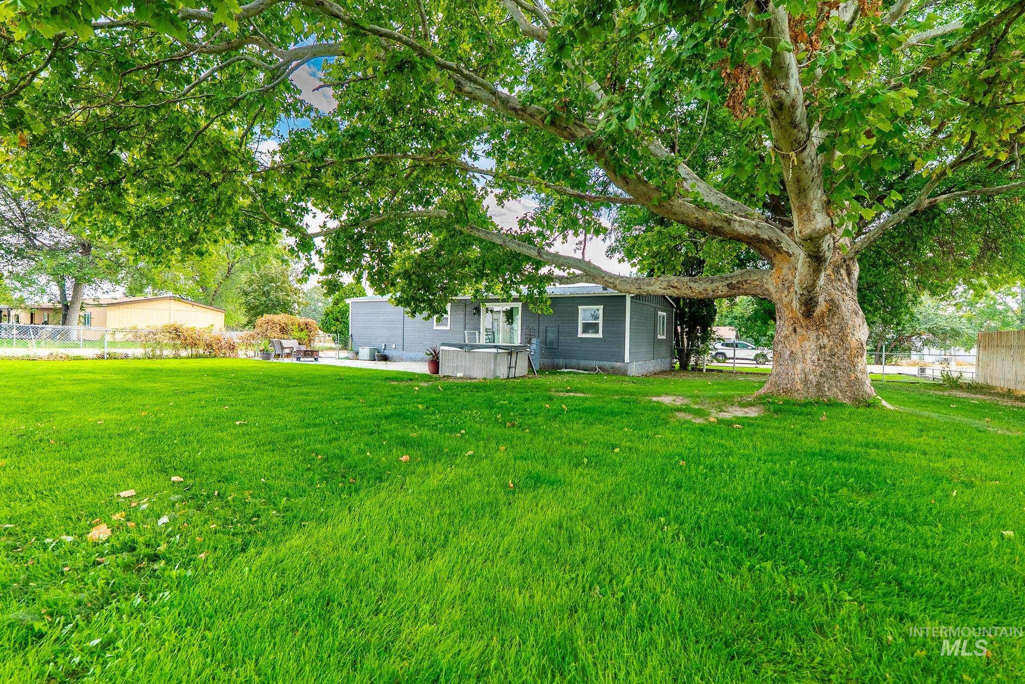 View of yard featuring a hot tub and a patio area