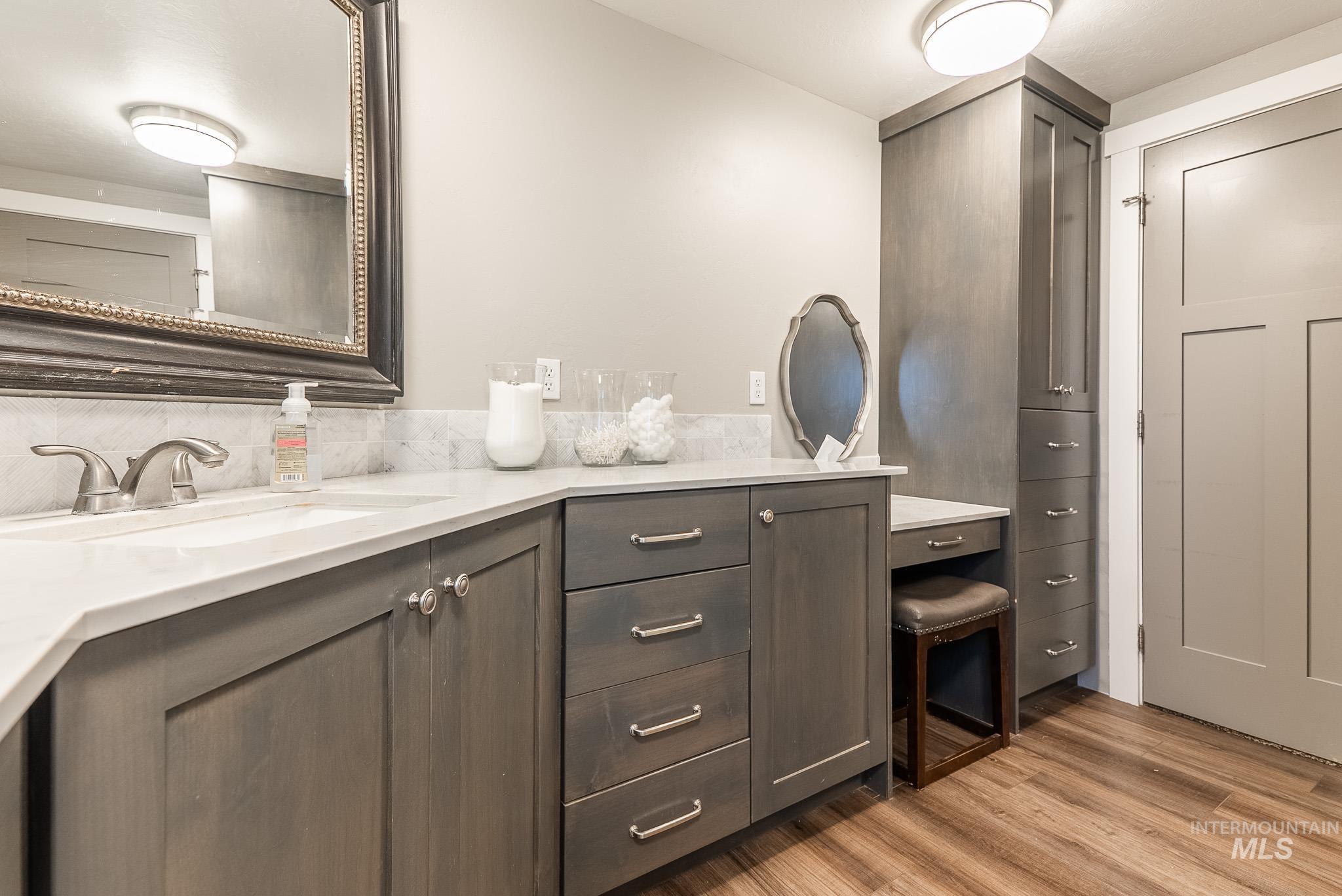Bathroom featuring double vanity and light wood-style floors