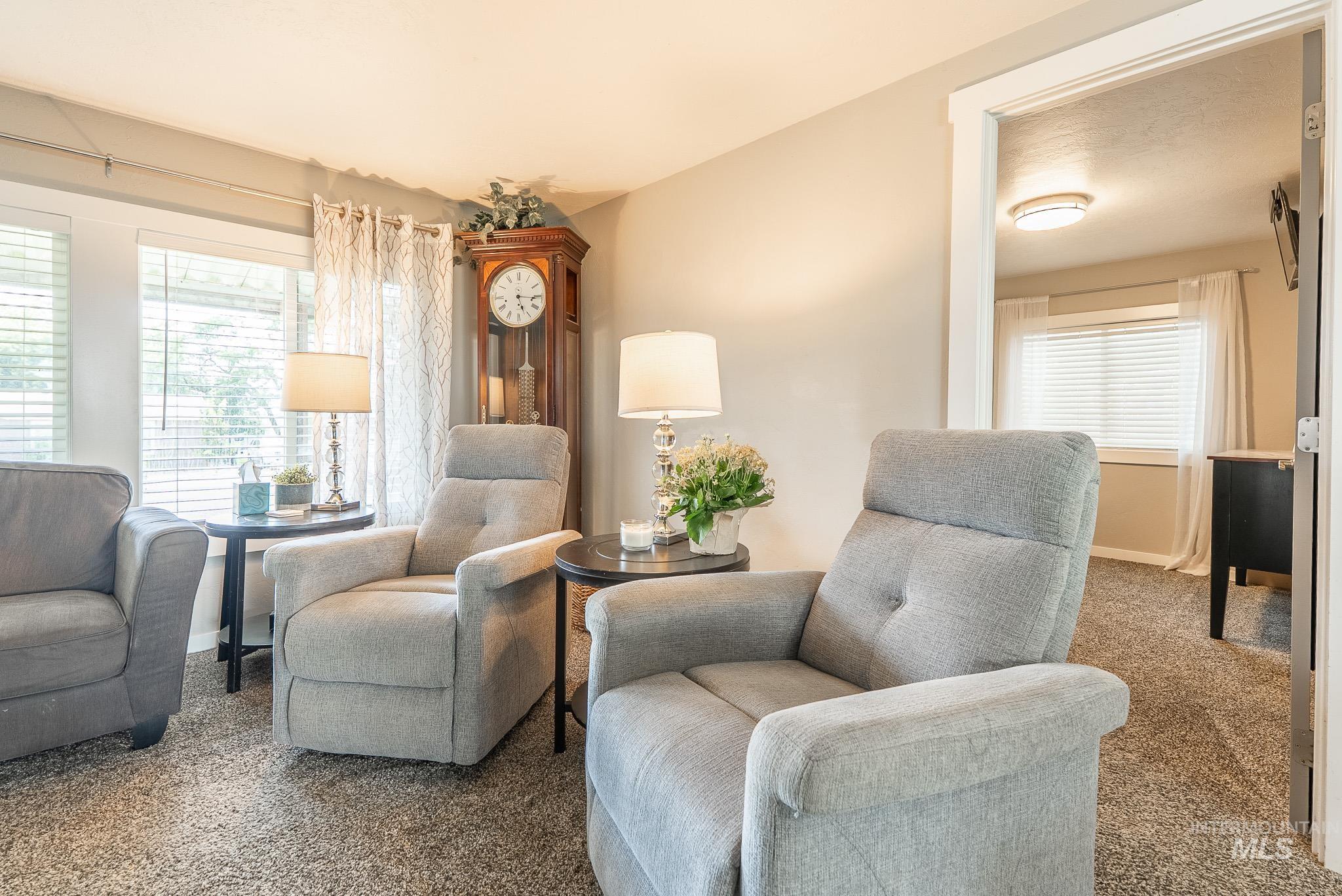Sitting room featuring carpet floors and plenty of natural light
