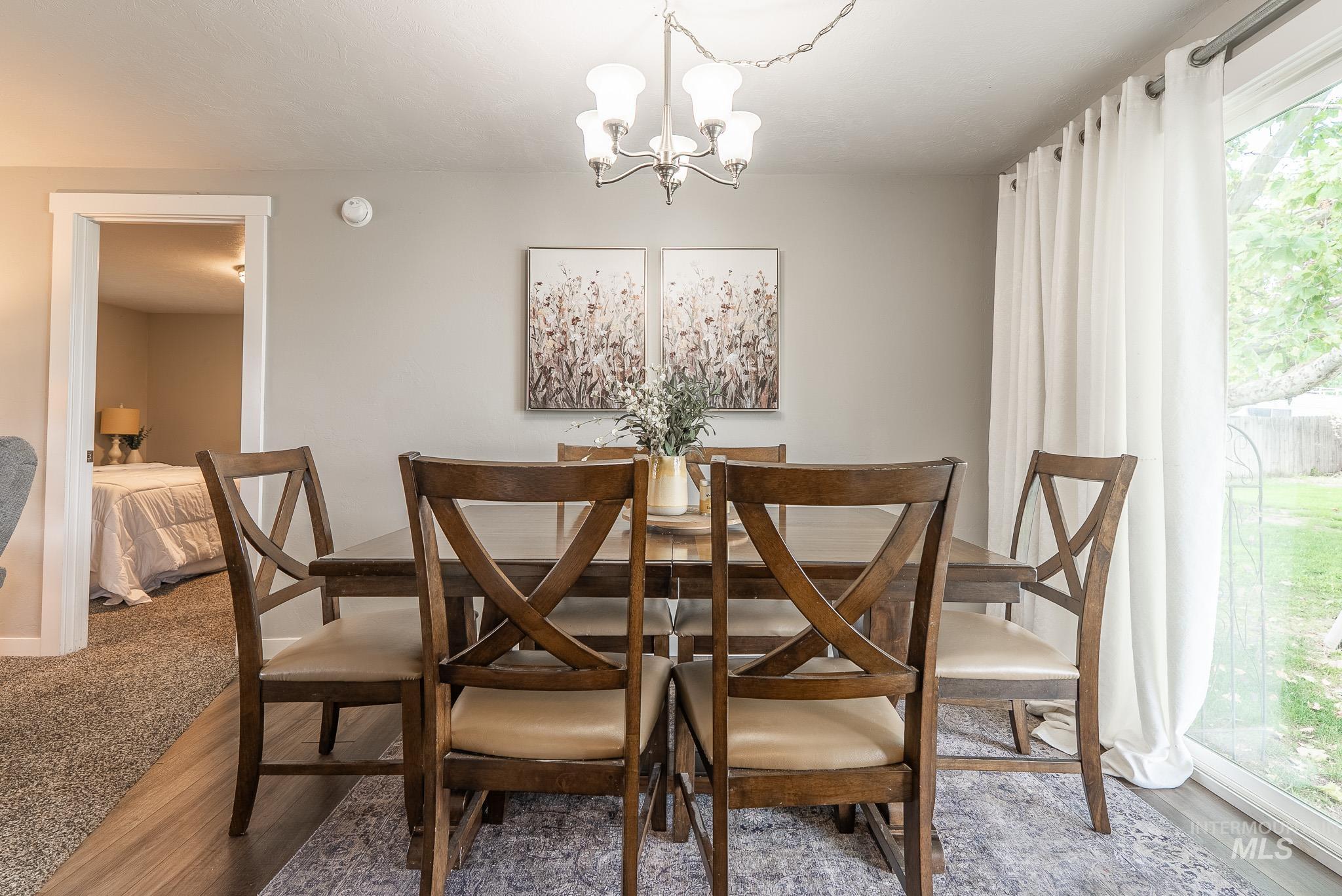 Dining room with a chandelier and wood finished floors