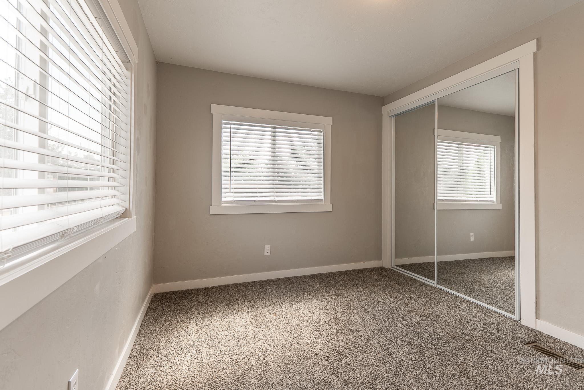 Unfurnished bedroom featuring carpet floors and a closet