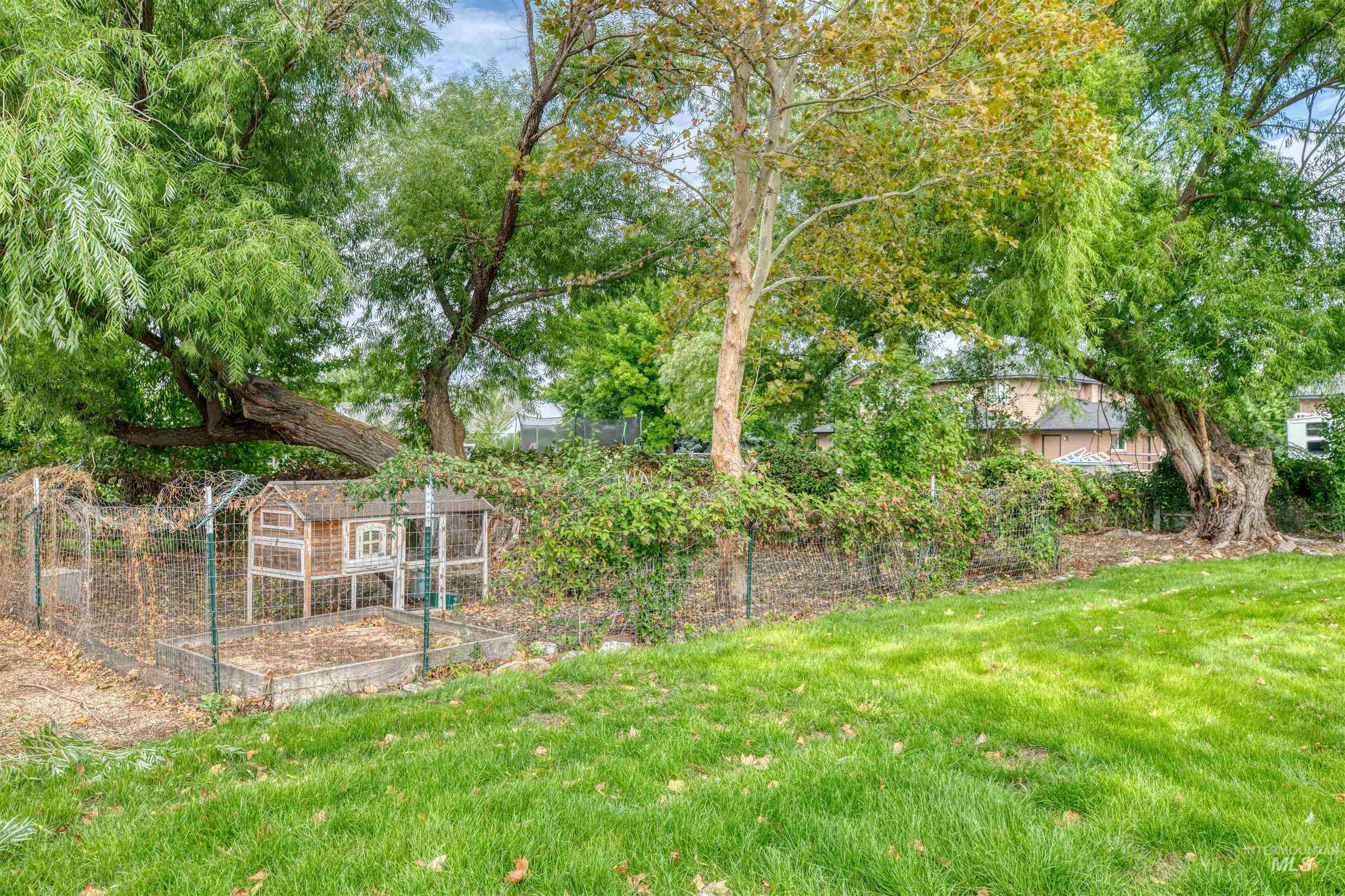 View of yard featuring an outdoor structure and a vegetable garden