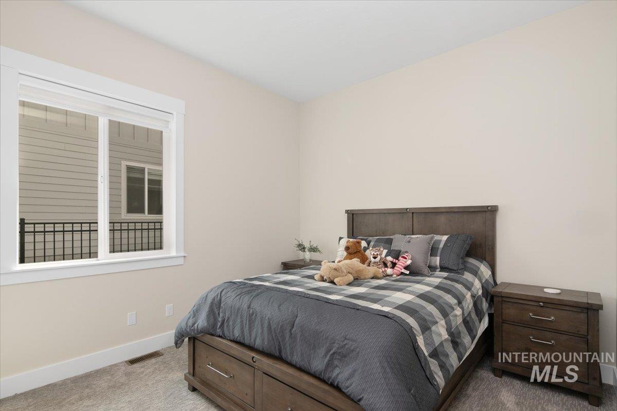 Bedroom with light carpet and baseboards