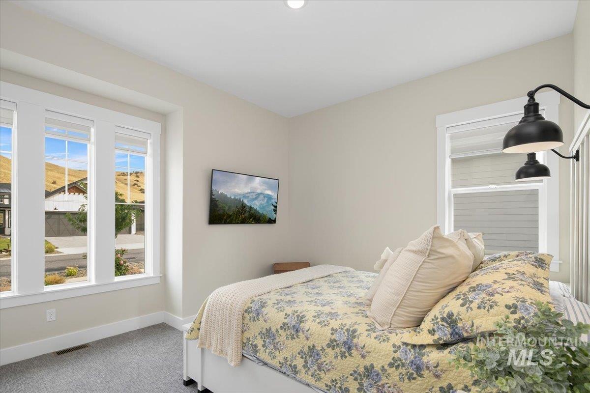 Carpeted bedroom featuring baseboards