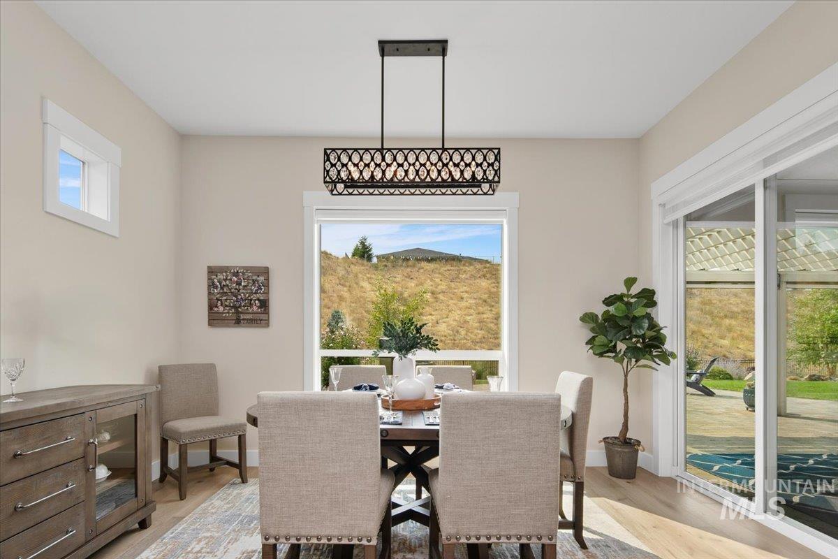 Dining area with light wood finished floors and baseboards