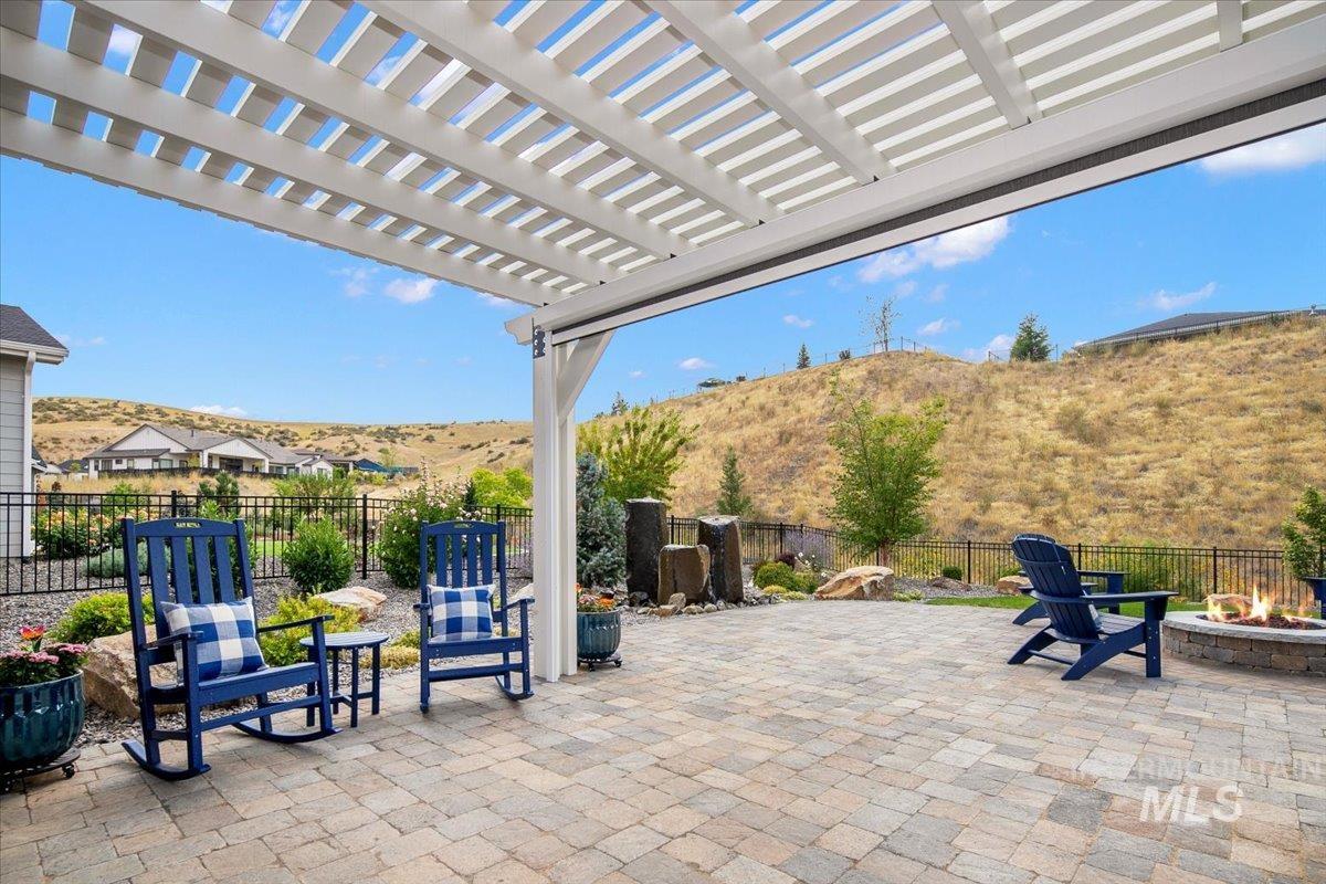 Fenced backyard featuring a pergola, a patio, and a mountain view