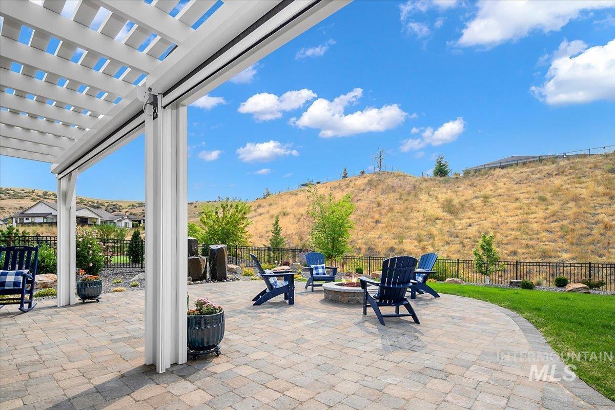 View of patio / terrace featuring a pergola and a fire pit