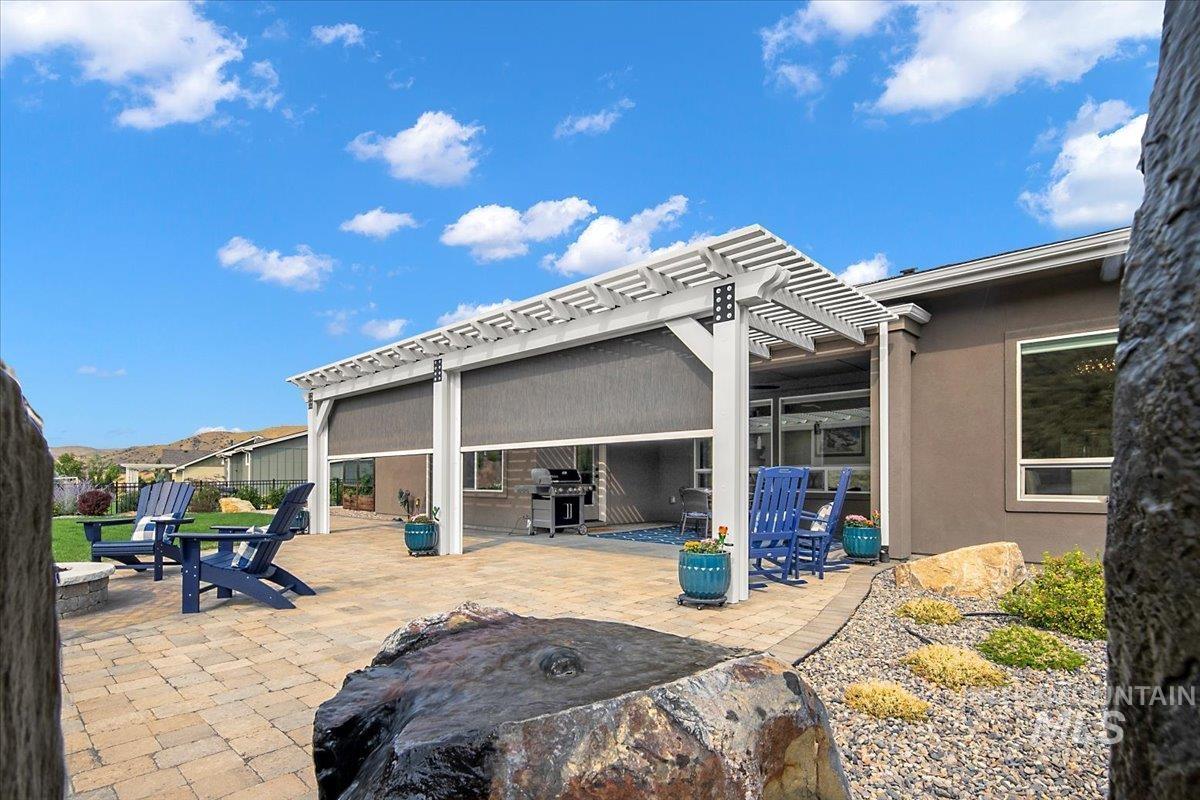 View of side of home with a patio area, stucco siding, and a pergola