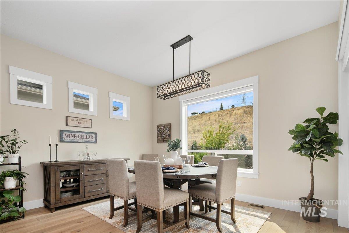 Dining space with light wood-style floors