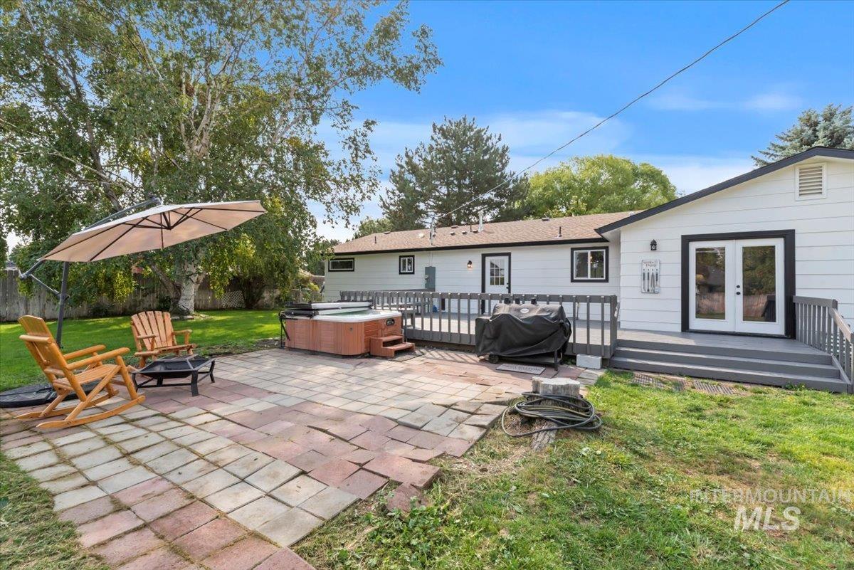 Back of property with patio, hot tub, and French doors