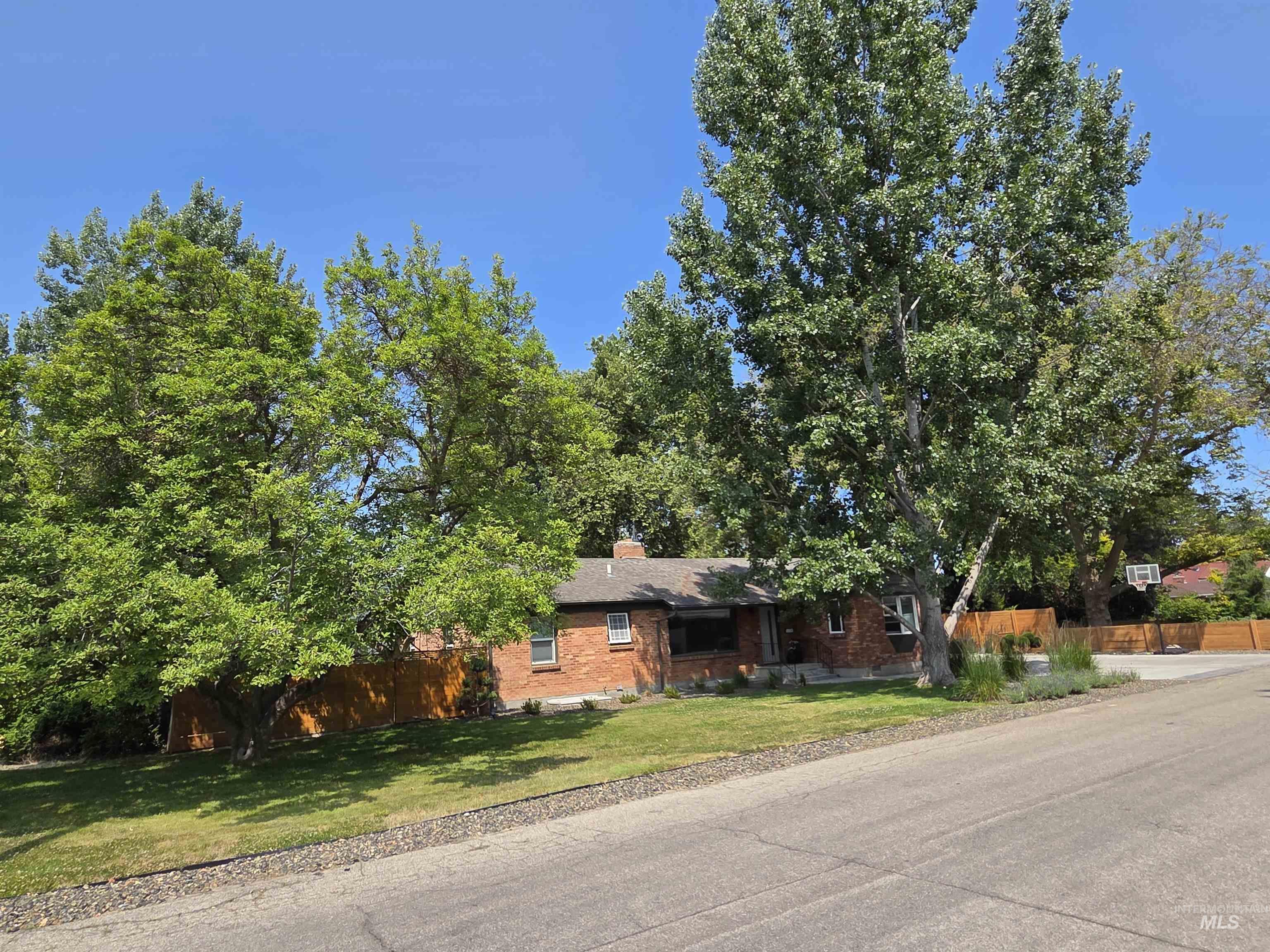 View of front of property with brick siding and a chimney