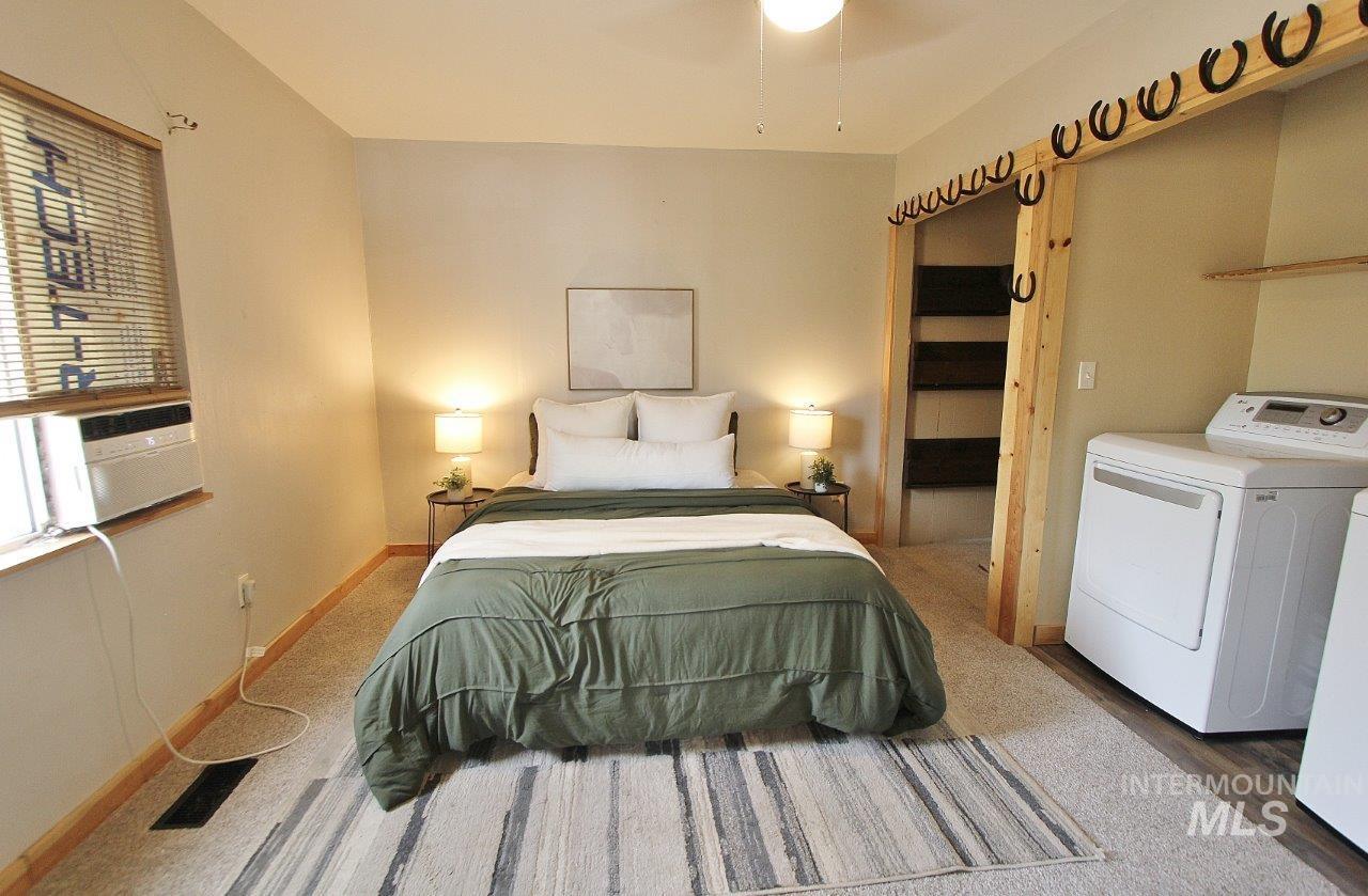 Bedroom with baseboards and cooling unit