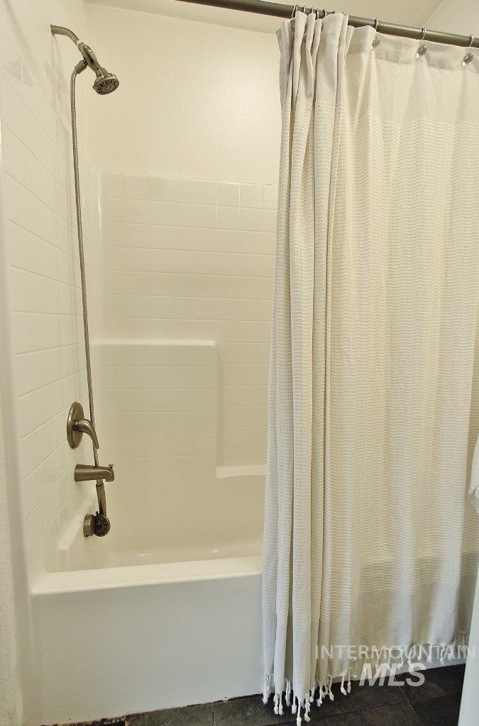 Full bath featuring shower / bath combo