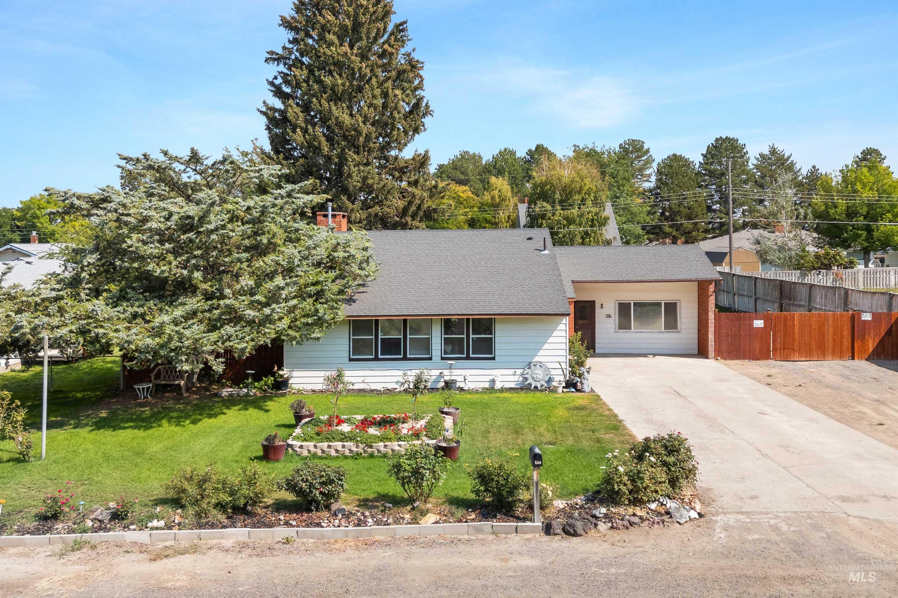 View of front of home with concrete driveway and a shingled roof