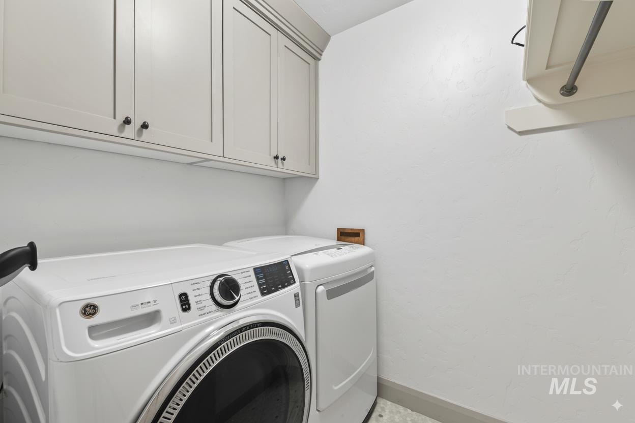 Laundry area with cabinet space and separate washer and dryer