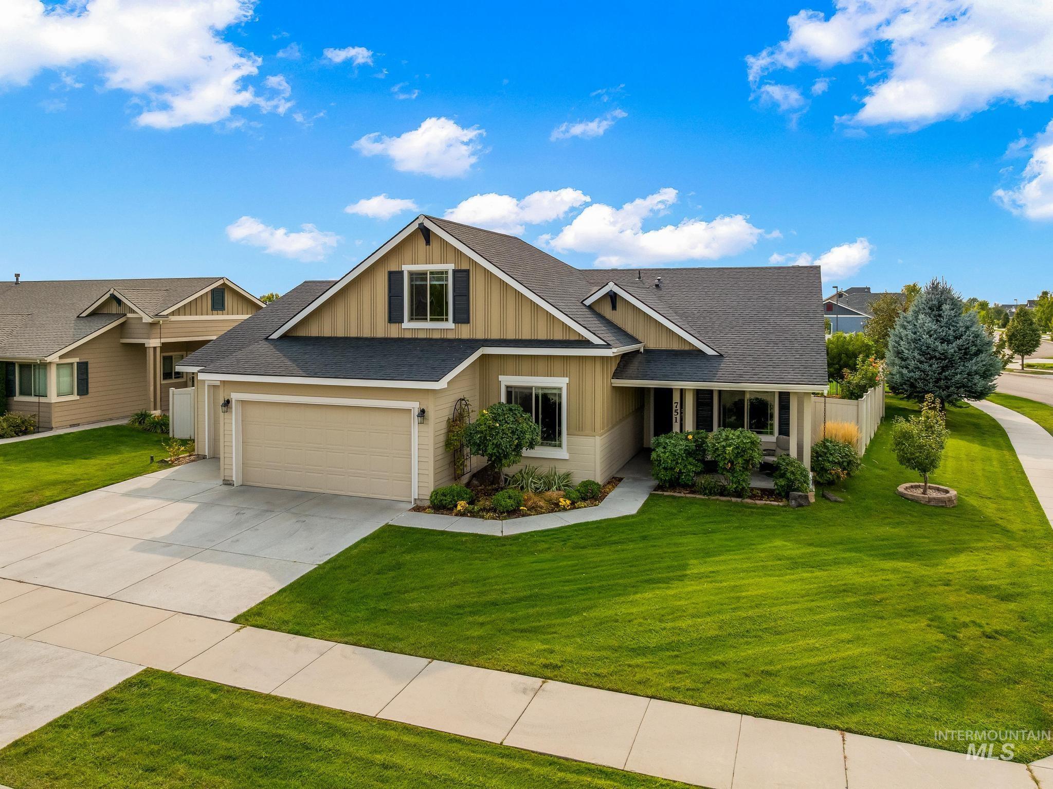 Craftsman-style home with a shingled roof, board and batten siding, concrete driveway, and covered porch