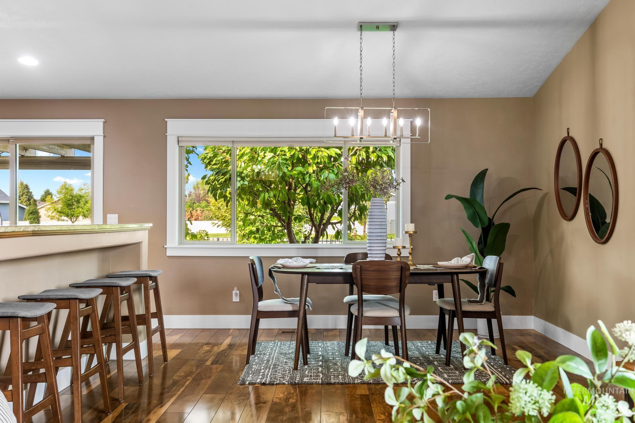 Dining space with dark wood finished floors and baseboards