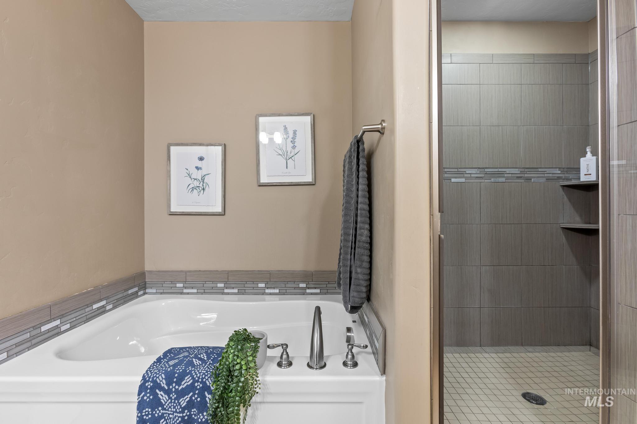 Full bath with a garden tub and a shower stall