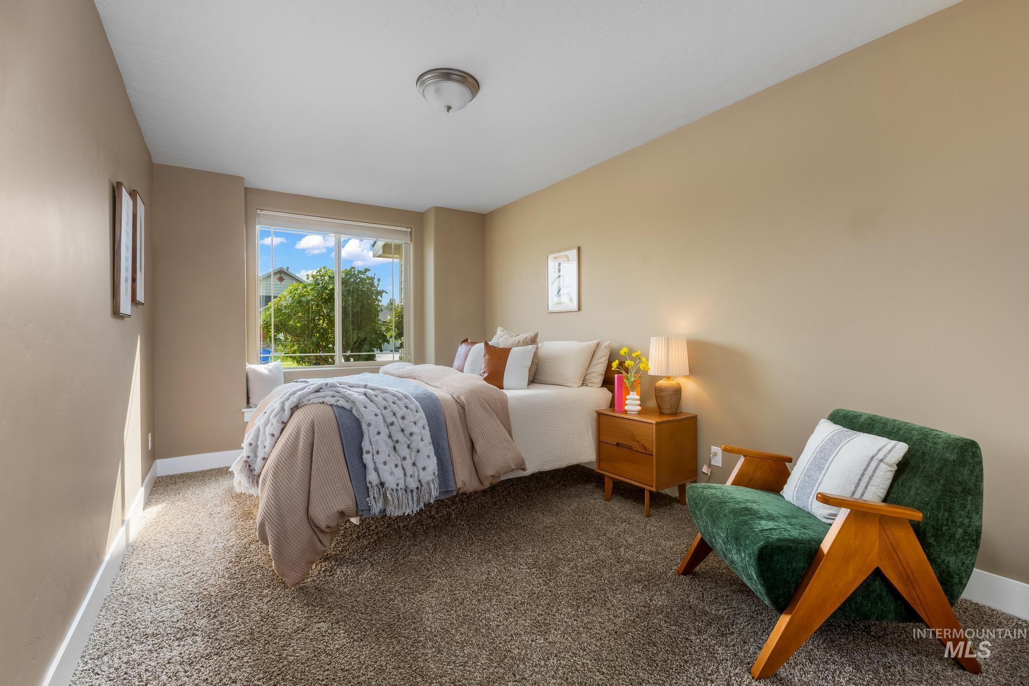 Bedroom featuring carpet flooring and baseboards