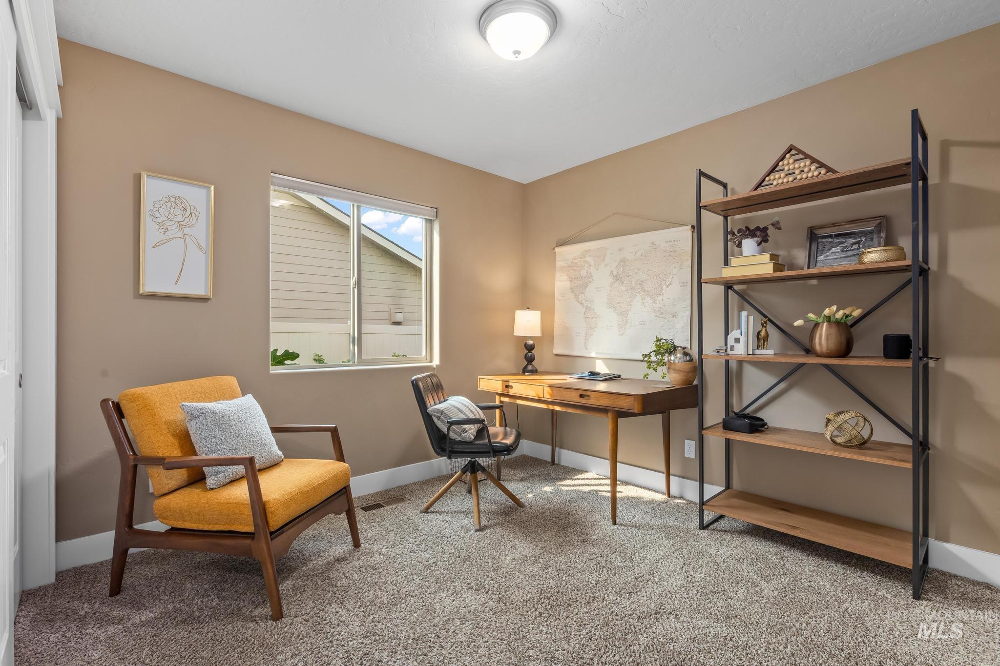 Home office with light carpet and baseboards