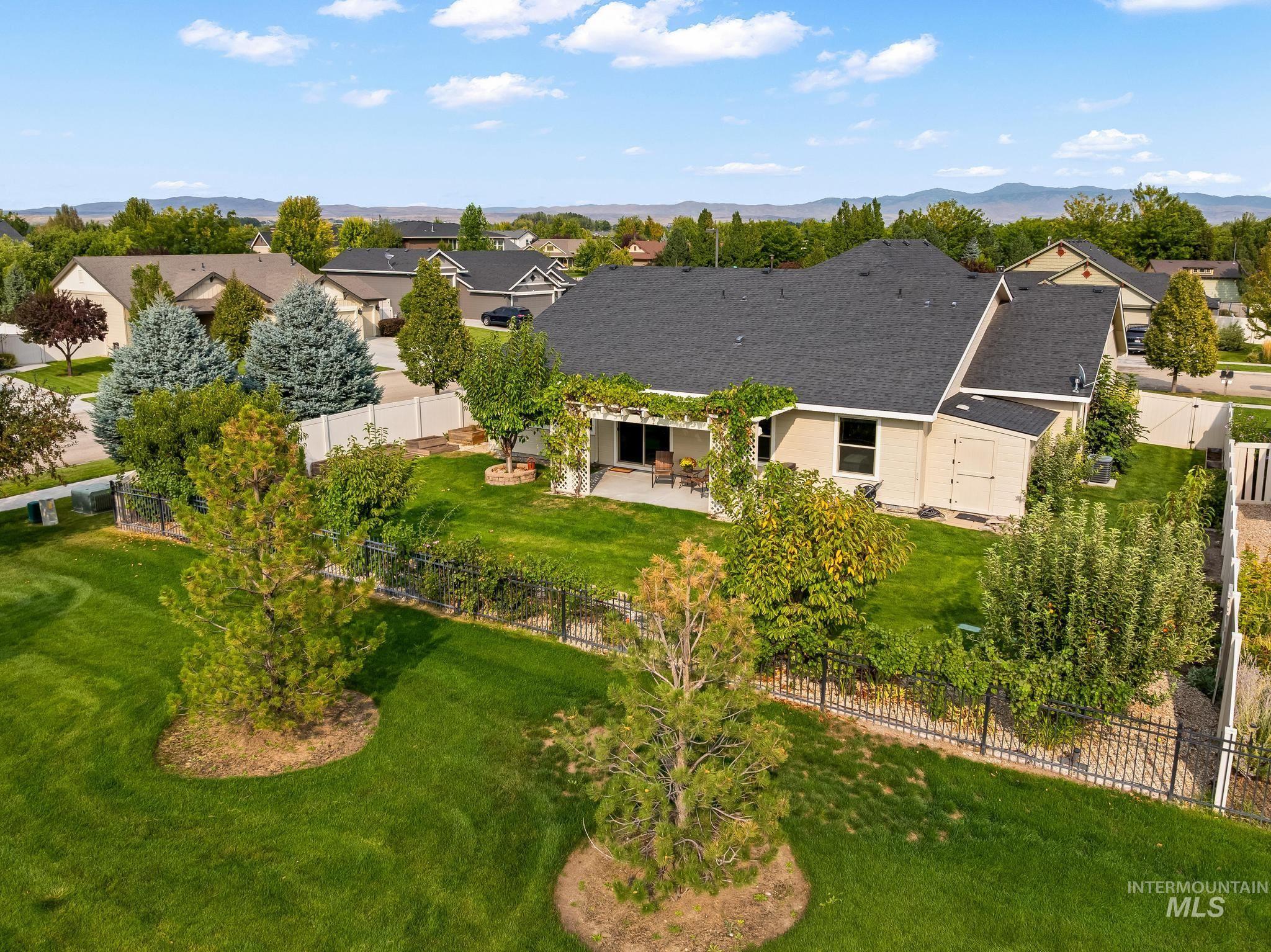Aerial perspective of suburban area featuring a mountainous background