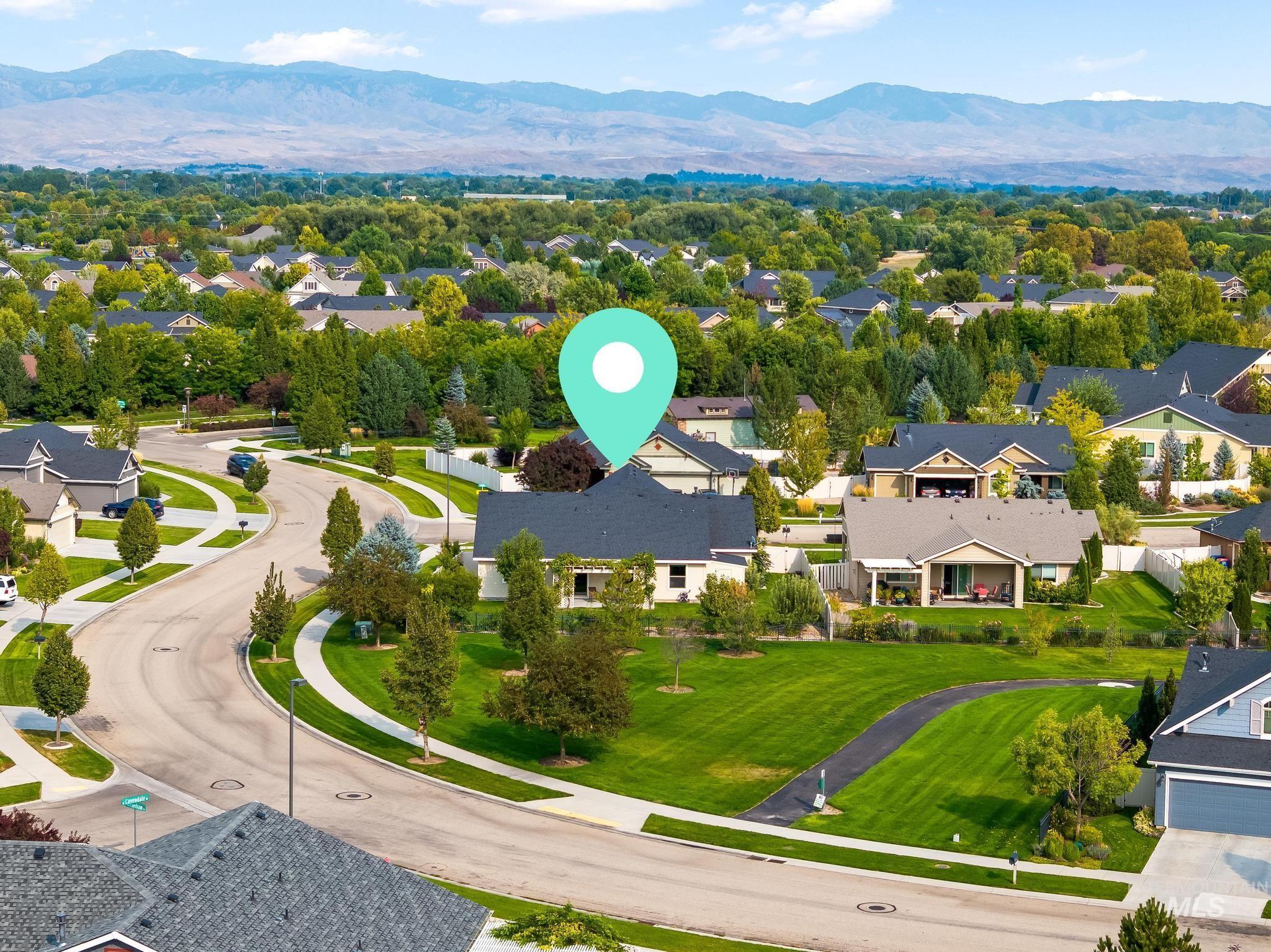 Aerial perspective of suburban area featuring a mountainous background