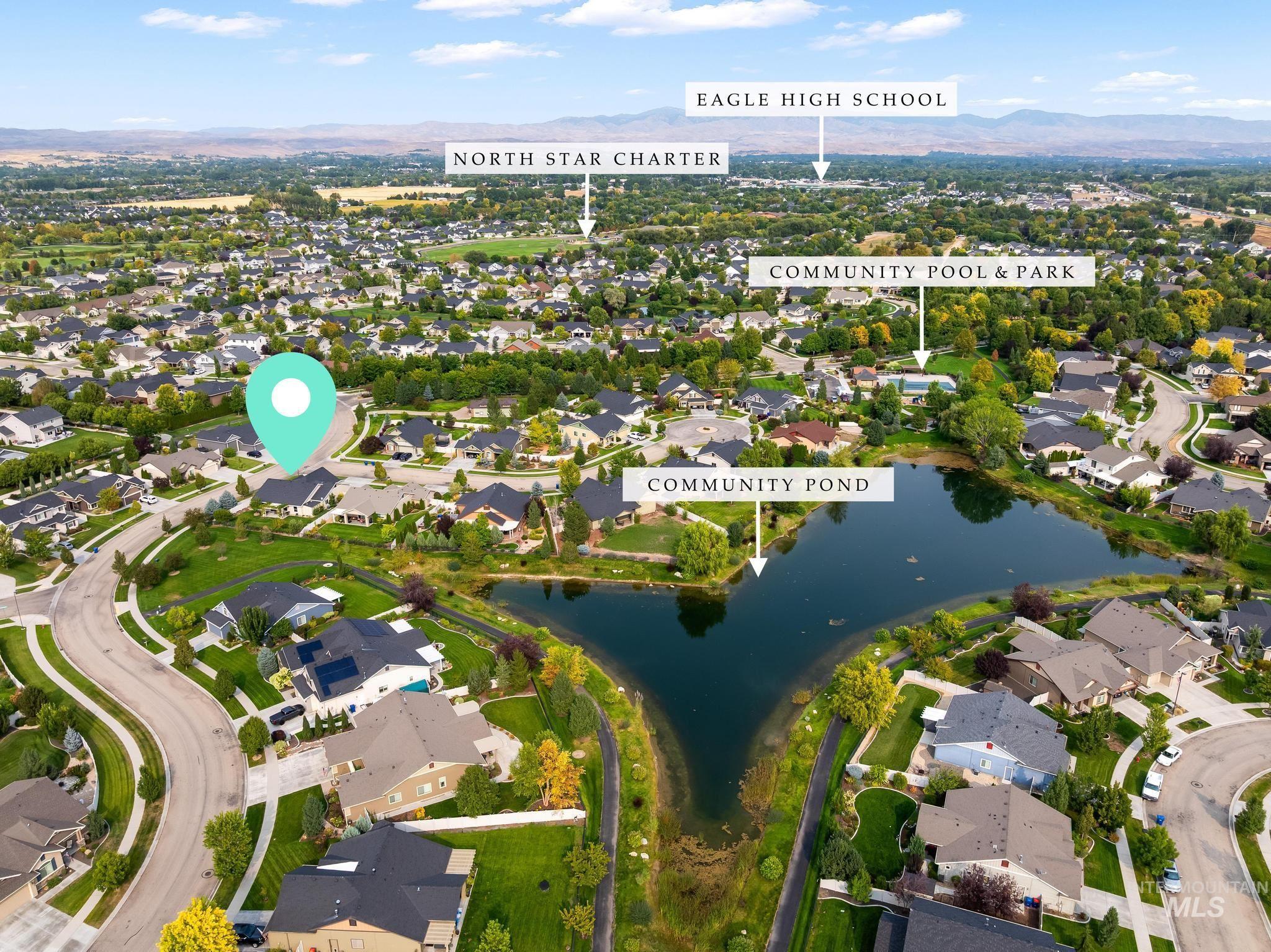 Aerial overview of property's location featuring nearby suburban area and a water and mountain view