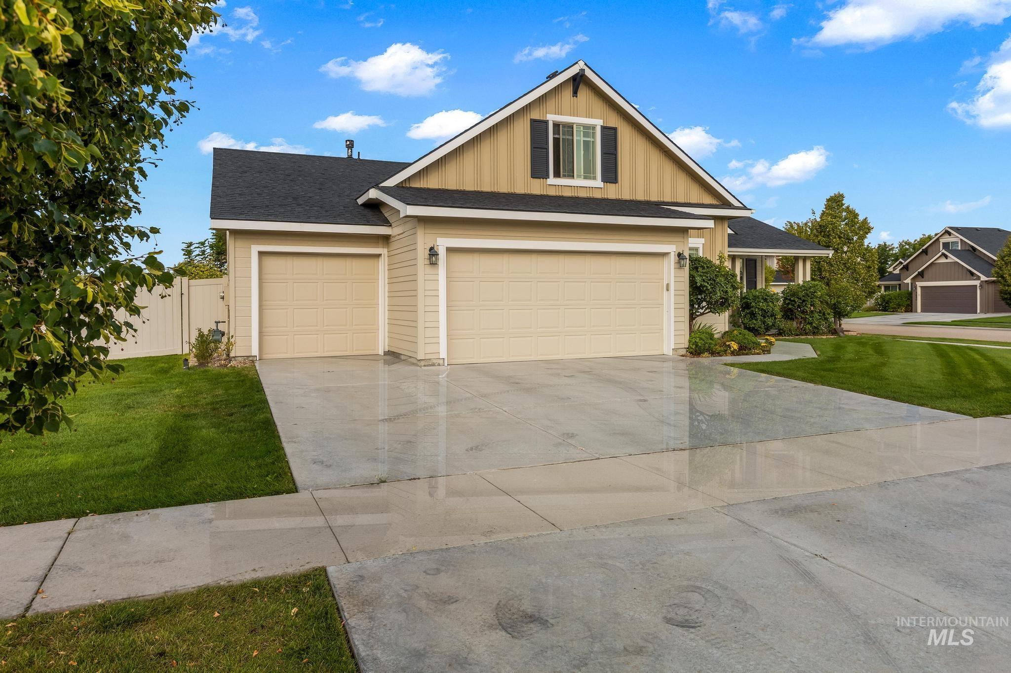 Craftsman inspired home with driveway, a shingled roof, and board and batten siding