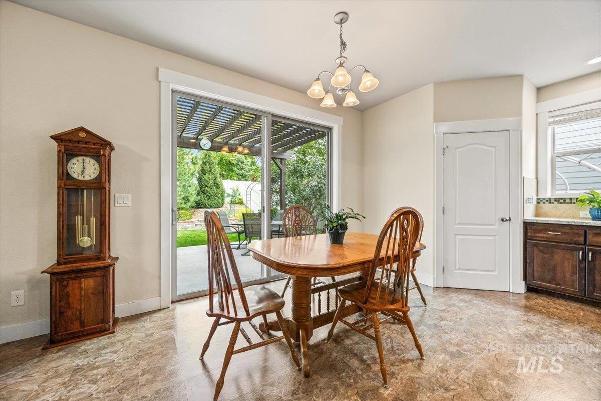 Dining room with a chandelier and baseboards