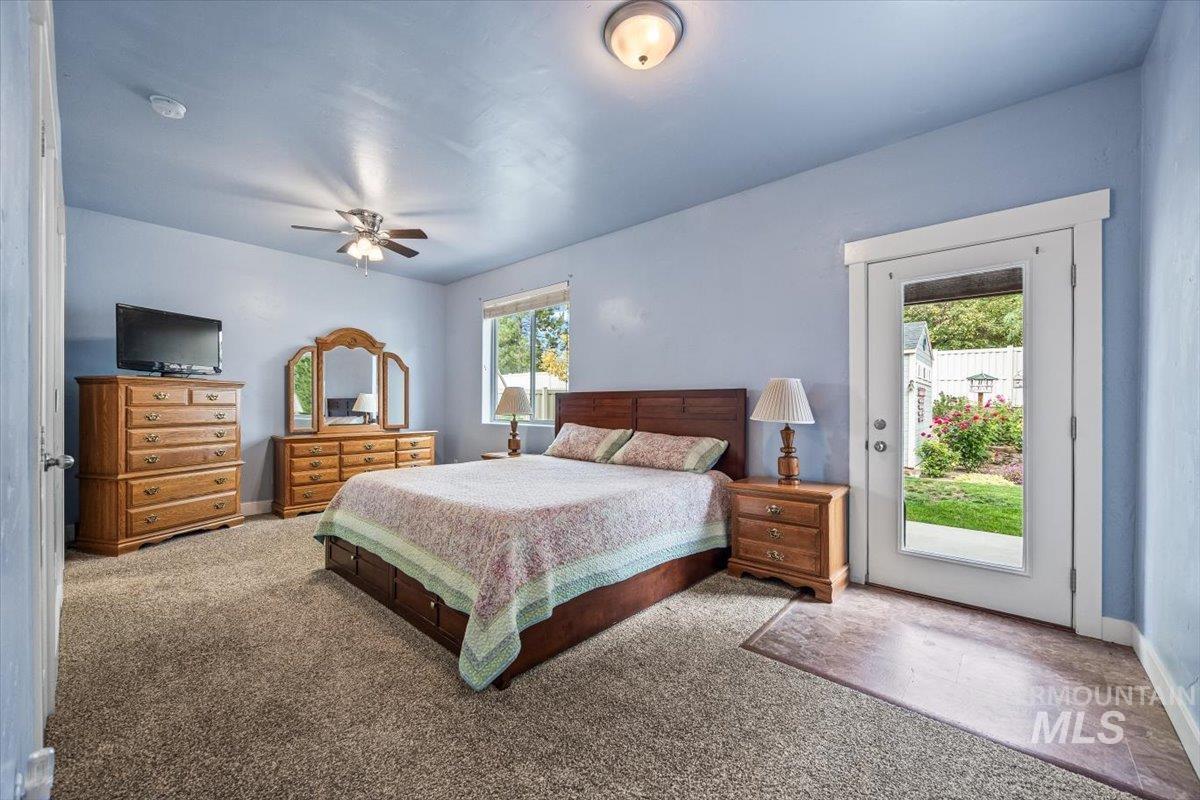 Bedroom featuring carpet flooring, access to exterior, and ceiling fan