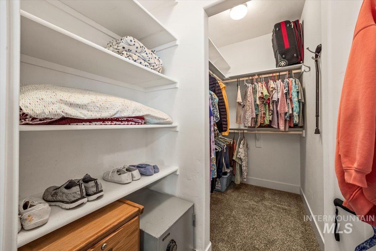 Walk in closet with dark carpet