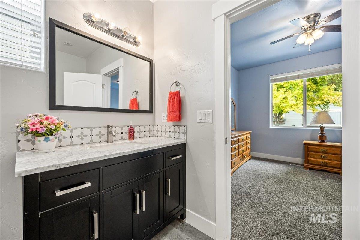 Bathroom featuring vanity and ceiling fan