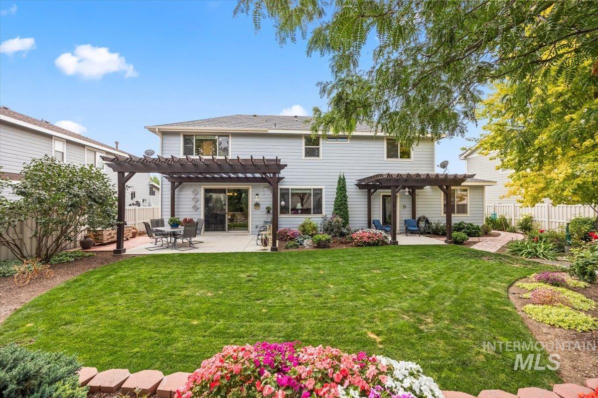 Back of property with a pergola and a patio area