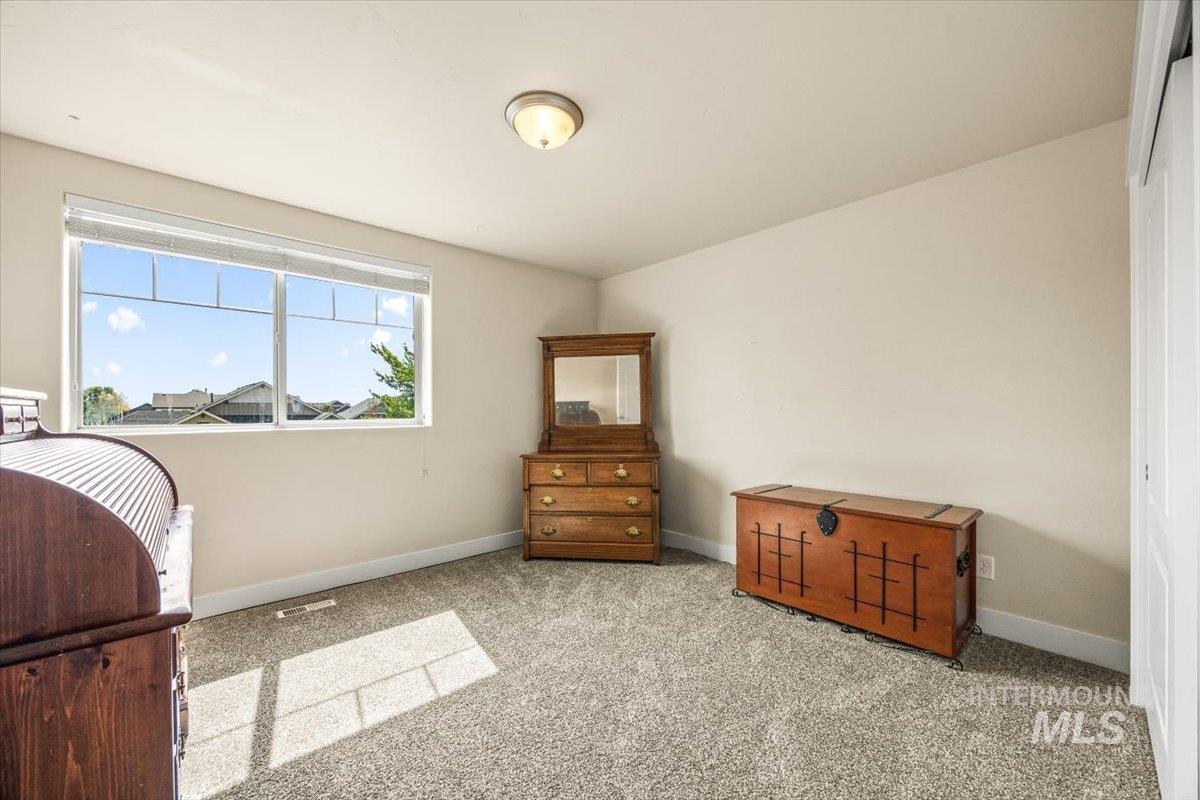 Carpeted bedroom featuring baseboards